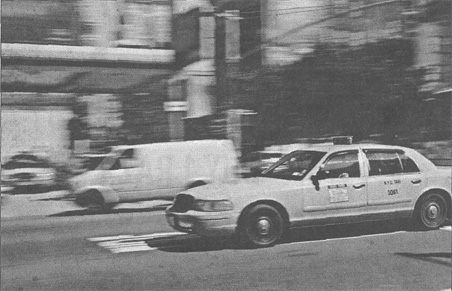 Photo of a New York City taxicab riding on the street