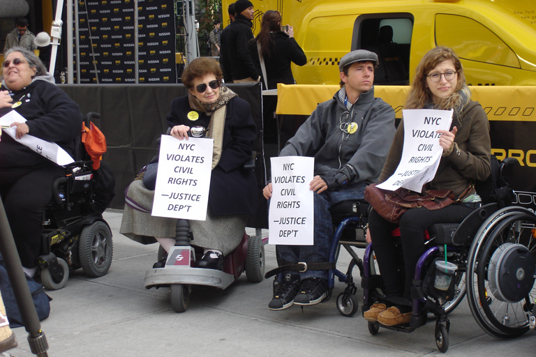 photo of demonstrators holding signs