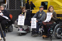 photo of demonstrators holding signs