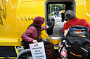 photo of women in wheelchairs in front of inaccessible entrance to Taxi of Tomorrow