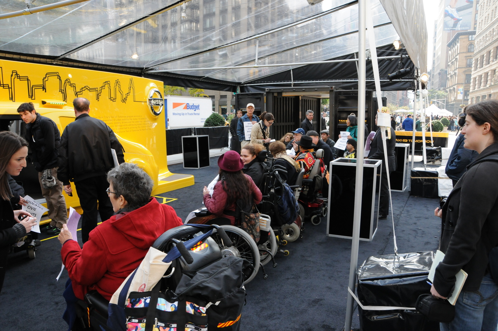 photo of demonstrators protesting the new Taxi of Tomorrow under an overhead plastic tent