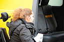 photo of two demonstrators in wheelchairs looking at Taxi's inaccessible entrance